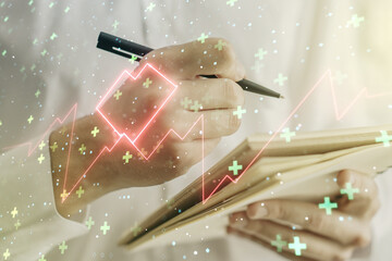 Creative abstract heart rate sketch and man hand writing in notepad on background, Medicine and...