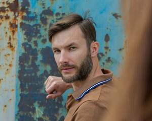 man looks to the side suspiciously and wary, close-up.