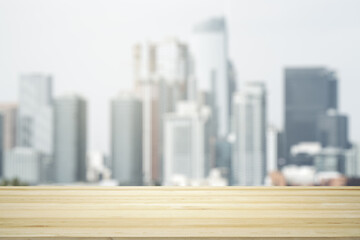Blank tabletop made of wooden planks with beautiful blurry cityscape in the afternoon on background, mockup