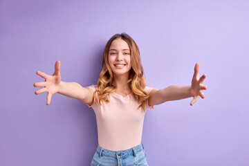 Nice Teen Girl Spreading Arms, Going To Hug, Smiling At Camera, In Casual T-shirt, Portrait Of Young Friendly Pleasant Teenager Girl With Wavy Blonde Hair