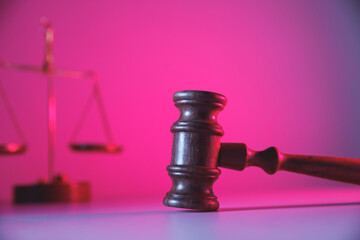 Scales of justice and wooden judge gavel in courtroom