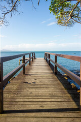 Naklejka premium Deck on the beach with a beautifull landscape view of the ocean and nature. Blue sky