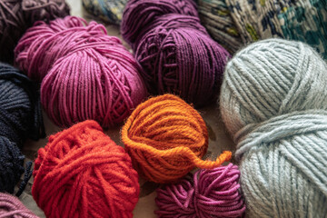 Detailed view on several balls of wool in diverse colors