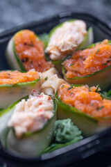 set of sushi rolls with seafood on a black stone background