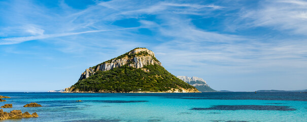 Sunning view of Figarolo island bathed by a turquoise water during a sunny day. Figarolo is an...
