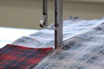 Textile industry, clothing production. Women's knitwear. Close-up of the cutter
