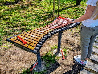 Girl playing musical instruments in the public park