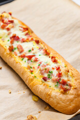 baked baguette filled with cheese and ham