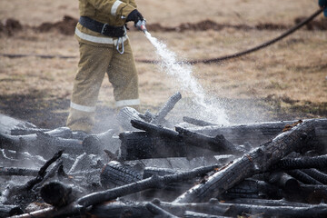 firefighters on the ashes. completed work on extinguishing the fire. analysis of the rubble of...