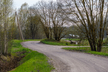 narrow countryside forest road with gravel surface