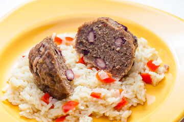meat balls filled with red beans on rice with red pepper