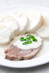meat with cream sauce and dumplings