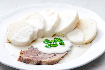 meat with cream sauce and dumplings