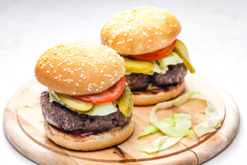 homemade hamburger with pickled cucumber and tomato