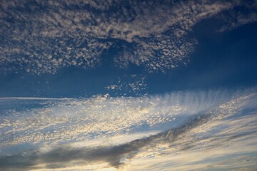 Naklejka na ściany i meble Skyscape with alto cumulus clouds at dusk