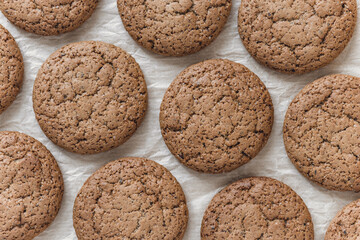 Crispy oatmeal cookies on pergament paper sheet. Close up photo high resolution