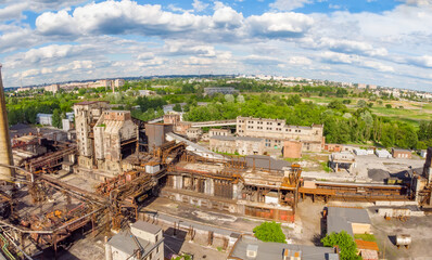 Aerial drone shot of old industrial zone with smoke stack. Air pollution concept