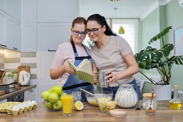 Mom and teenage daughter preparing apple pie in kitchen together