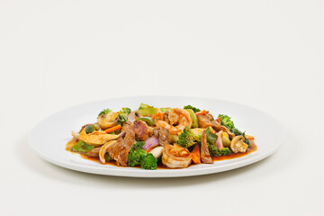 Chinese food with meat, shrimps and vegetables.