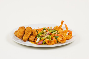 Chinese food with vegetables and fried shrimp and chicken.