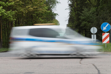 Motion blurred rescue service is moving fast at the intersection