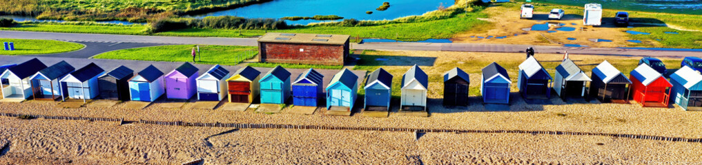 Banner - picturesque aerial image of colorful beach huts by the sea near Southampton in Hampshire, the South of England, taken using a drone. - 434819476