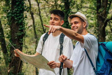 young people traveling with excursion or hiking map