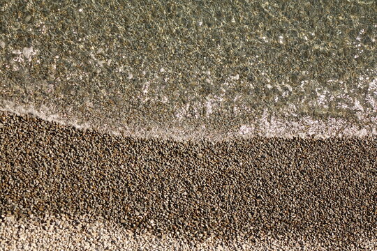 Pebble Beach Background Top View. Isolated Background Of Sea Beach With Diagonal Line Separating Claim Ocean Sea Lake Water. Shingle Beach Ar Or Claim Water Texture. Nature Wallpaper.