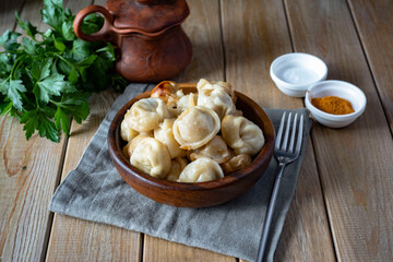 Dumplings in a beautiful wooden plate on a wooden table