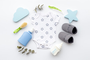 Flat lay of baby boy bodysuit with malk bottle. Baby background