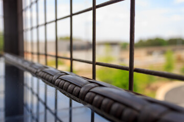 Table out looking blurry train station through a fence