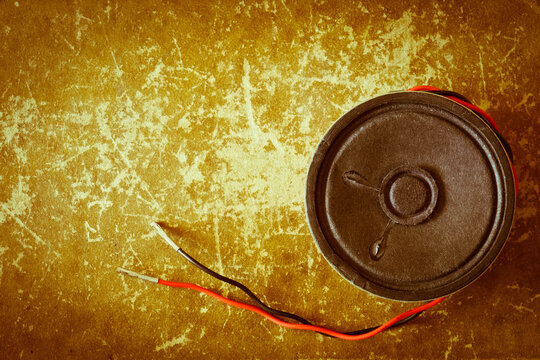 Unplugged Vintage Sound Speaker On A Grungy Scrapped Book Cover Background