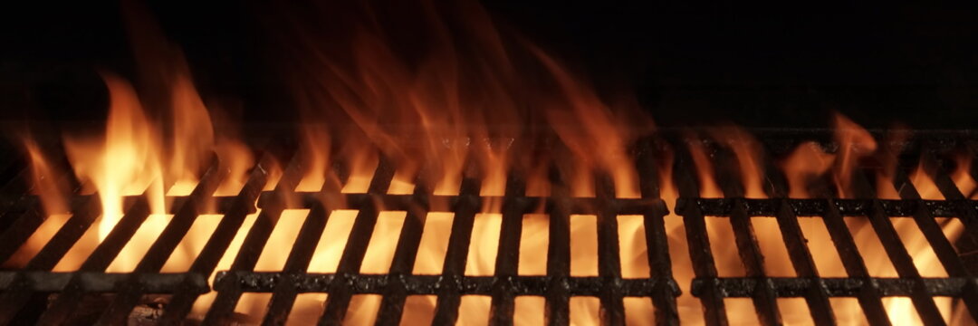 Barbecue Fire Grill Isolated On Black Background. BBQ Flaming Charcoal Grill Isolated. Hot Barbeque Charcoal Cast Iron Grill With Bright Flames Of Fire. Abstract Panoramic Grill Wide Banner.