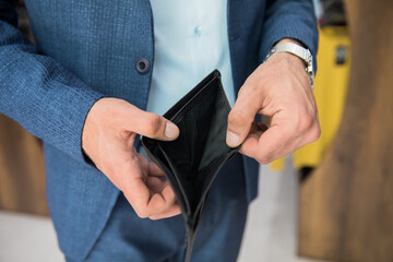 man holding empty wallet