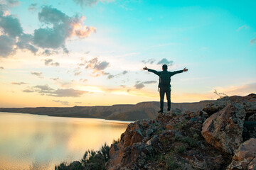 Fototapeta na wymiar happy man in rock with lake background