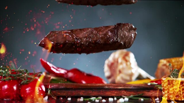 Close-up of Falling Tasty Beef Steaks, Super Slow Motion, filmed on High Speed Cinematic Camera at 1000 fps.