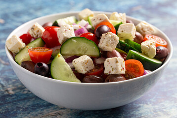 Bowl of Fresh Greek Salad with Cucumbers Tomatoes Olives and Feta Cheese