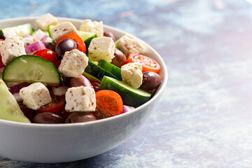 Bowl of Fresh Greek Salad with Cucumbers Tomatoes Olives and Feta Cheese