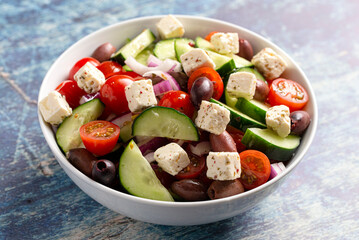 Bowl of Fresh Greek Salad with Cucumbers Tomatoes Olives and Feta Cheese