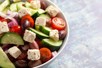 Bowl of Fresh Greek Salad with Cucumbers Tomatoes Olives and Feta Cheese