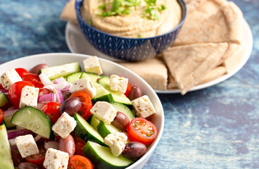 Bowl of Fresh Greek Salad with Cucumbers Tomatoes Olives and Feta Cheese