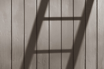 Shadows of a ladder on a wall.