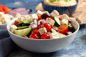 Bowl of Fresh Greek Salad with Cucumbers Tomatoes Olives and Feta Cheese