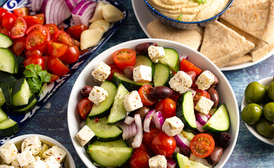 Bowl of Fresh Greek Salad with Cucumbers Tomatoes Olives and Feta Cheese