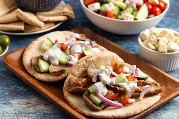 Gyros with Vegetables and White Garlic Sauce on a Rustic Wooden Table