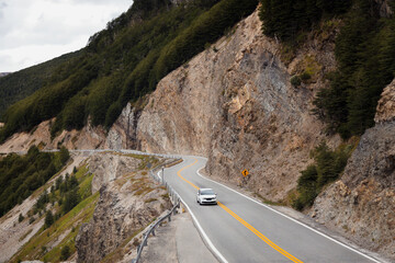 An empty road trip. Traveling through a Patagonia mountain route by car. Peaceful vacation concept....