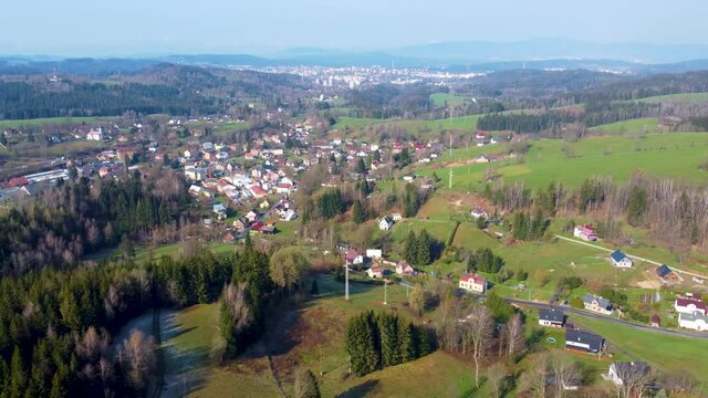 Rural mountain landscape on springtime sunny day. Lucany nad Nisou and Jablonec nad Nisou in Jizera Mountains. Czech Republic. Truck right aerial 4K footage from drone