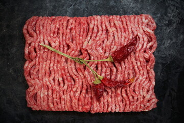 Raw Minced Meat On Black Vintage Background. Top View Of Fresh Ground Beef Isolated On Black Background. Uncooked Minced Mixed Beef And Pork Meat.
