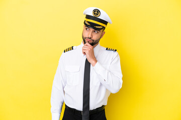 Airplane arab pilot man isolated on yellow background and looking up