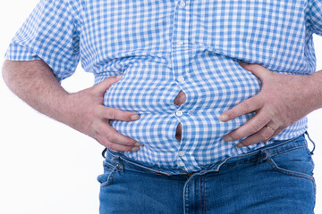 Close up of a tight shirt of a man with overweight, typical photo for beer belly: Selective focus. 
